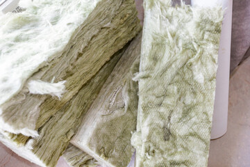 Pieces, parts of rock wool are waiting for installation, interior