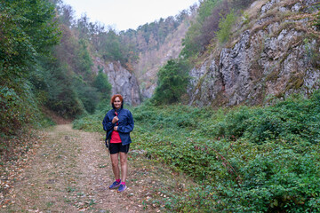 Wall Mural - Woman hiker in a rainy day