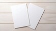 © mangolovemom - Two white sheets of paper are sitting on a wooden table