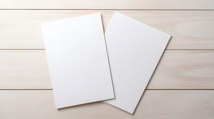 two white sheets of paper are sitting on a wooden table