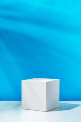 Poster - A clean white cube positioned on a minimalist surface against a vibrant blue backdrop