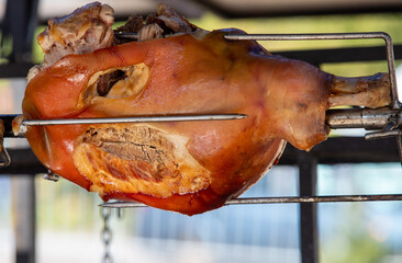 A piece of meat is being cooked on a grill