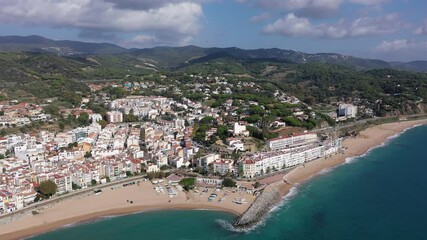 Wall Mural - Birds eye view of Sant Pol de Mar, Spain. Residential building along Mediterranean sea coast and beach visible from above.