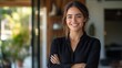 © ifoto - Portrait of a beautiful smiling female real estate agent standing in front of her modern house with arms crossed