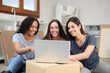 © Antonioguillem - Three women checking laptop moving home