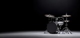 Classic black drum set under spotlight, low-key stage lighting, emphasizing chrome hardware and glossy drum shells, concert performance preparation, cinematic mood
