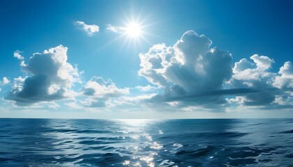 Sunny seascape with blue sky and rippling water, surrounded by soft clouds