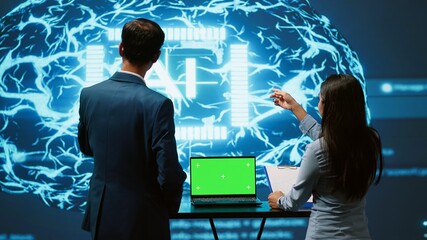 Poster - AI developers using isolated screen device for business data analysis. IT department staff members work on chroma key notebook to automatize tasks using artificial intelligence, camera A