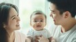 © Nick - Asian parents with their baby father and mother looking at their child Chinese Japanese Korean Taiwanese