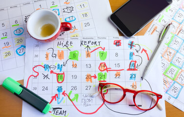 Calendar with business appointments,pens,coffee cup and spectacles, monthly schedule. Business concept,beat the clock.