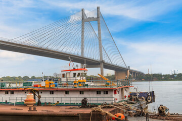 An old jetty on the Ganges river with view of the cable-stayed Vidyasagar Setu bridge in the background at Kolkata, India.