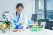 © Phushutter - Two Asian women in a lab work on food research, using a microscope, petri dish, and test tubes filled with chemical solutions. They study vegetables, pork, and plants for GMO traits and nutrition.