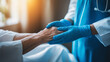 © Curioso.Photography - Healthcare professional holding an elderly patient's hand, symbolizing care and support.