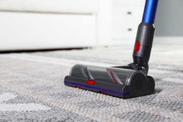 Sticker - Cleaning with wireless vacuum cleaner at home, closeup. Space for text