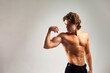 © Alex Vog - Portrait of handsome man muscular fashion model with abs press showing arm muscle bicep, studio shot. Sporty healthy strong muscle guy with perfect sexy bare torso, white backdrop. Copy ad text space
