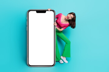 Wall Mural - photo of crazy girl appear from cellphone design board presenting electronic brand isolated blue col