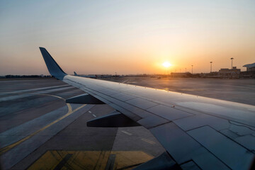 Canvas Print - View on sunset and airplane wing from the inside