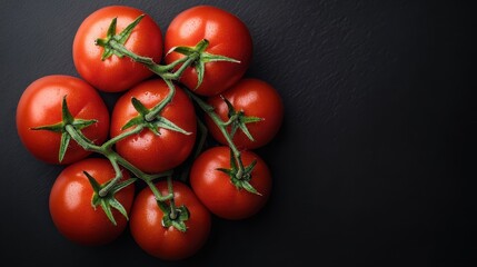 A vibrant cluster of fresh vine tomatoes rests on a dark, textured surface, showcasing the rich red hues and natural beauty of ripe produce in a minimalist presentation.