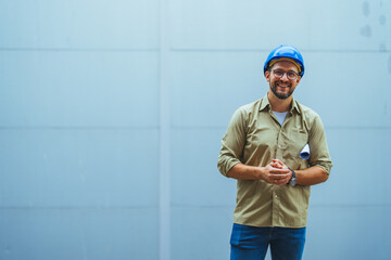 Smiling Engineer Wearing Hard Hat With Blueprints in Hand