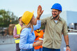 © Dragana Gordic - Construction Workers Celebrating Success With High Five