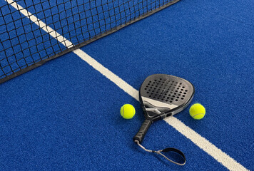 Paddle racket with a ball ready to play the fastest growing sport in recent years worldwide. Padel court in summer, the perfect time to practice this sporting discipline and release stress.