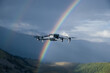 © lzf - Drone taking photo of rainbow with a drone on high altitude grassland mountain top