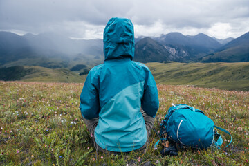 Poster - Woman hiker meditation on the high altitude mountain top grass