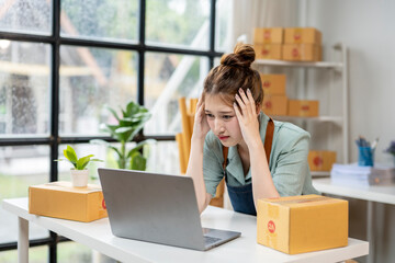 Wall Mural - A woman is sitting at a desk with a laptop in front of her