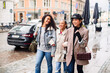 © Davor - Three diverse female friends walking together on city street