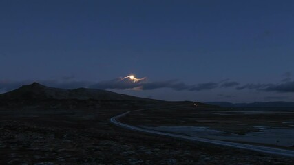 Wall Mural - road against the rising moon. night time-lapse. norwegian landscape.