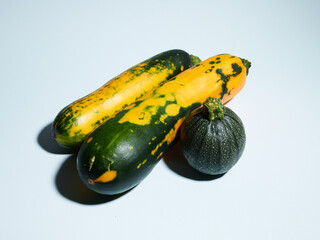 Wall Mural - Organic zucchini over blue background