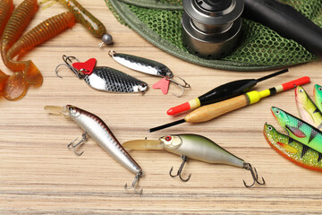 Sticker - Fishing baits, floats, net and spinning reel on wooden table