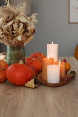 Wall Mural - Tray with many burning candles and autumn decor on wooden table indoors