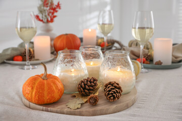 Wall Mural - Burning candles and autumn decor on table indoors