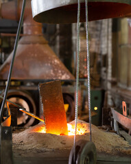 Wall Mural - Ferrous metal billet is melted in an induction furnace closeup