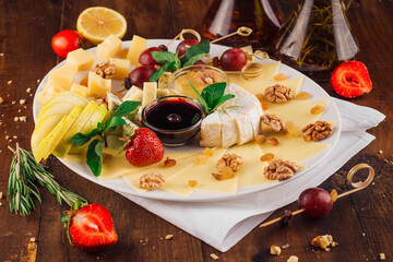 Delicious cheese platter with organic ingredients arranged on wooden table