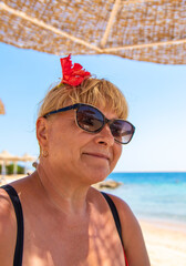 Wall Mural - Woman relaxing on the beach in the sea. Selective focus.