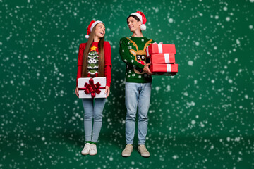 Wall Mural - Photo of dream couple hold stack giftbox present wear hat ugly pullover isolated green color background