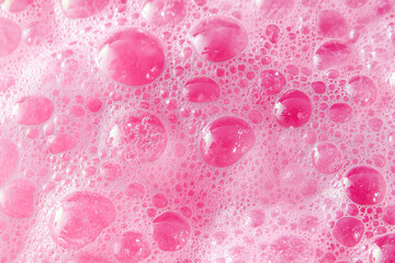 Poster - Close-up of pink soap bubbles creating a vibrant and bubbly texture. Perfect for backgrounds or hygiene-related themes.