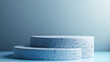 © tonstock - Minimalist blue terrazzo display stands on light blue surface with a subtle gradient background perfect for showcasing products or design presentations.