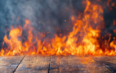 Poster - Close-up view of intense flames and fire on a wooden surface, creating dramatic contrast between the vivid fire and rustic wood.