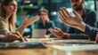 © Ganesha - Close-up of two business people having a discussion, with their hands and gestures in conversation at a meeting room with a blurred background office interior. This business concept suggests the idea