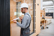 © Serhii - A worker is applying polyurethane foam to fill gap between sash and window frame in prefabricated modular house