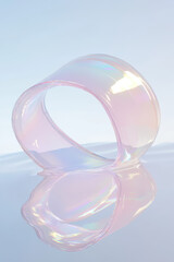 Poster - Abstract image of a translucent, iridescent loop structure against a soft gradient background, reflecting light and creating a dreamy atmosphere.