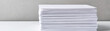 © tonstock - A stack of white paper neatly arranged on a plain background, ideal for office, school, or business purposes. Perfect for printing or writing.