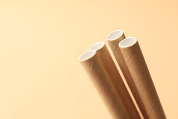 Sticker - Bamboo drinking straws on beige background, closeup. Space for text