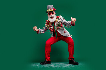 Wall Mural - Full size photo of elegant crazy man raise fists decorated blazer red pants isolated on dark green color background