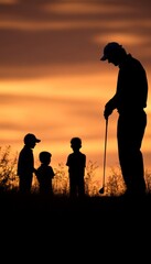 Canvas Print - Silhouette of a golfer with children at sunset.