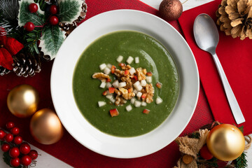 Spinach cream made with pear, vegetables and walnuts. Top view table with Christmas decorations.