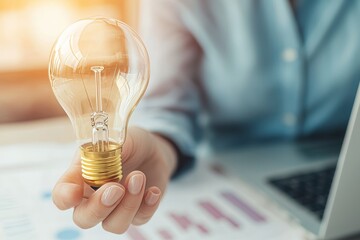 Poster - A creative business strategy is illustrated with a light bulb as a concept by a business hand